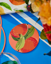 Round Summer paper coasters with a colourful fruit and green leaf print.