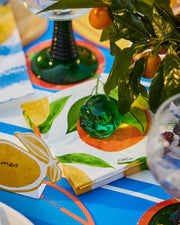 Summer paper cocktail napkins with an orange, green leaves and small floral details.