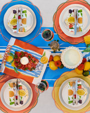 Summer paper table runner with white stripes on a blue background.