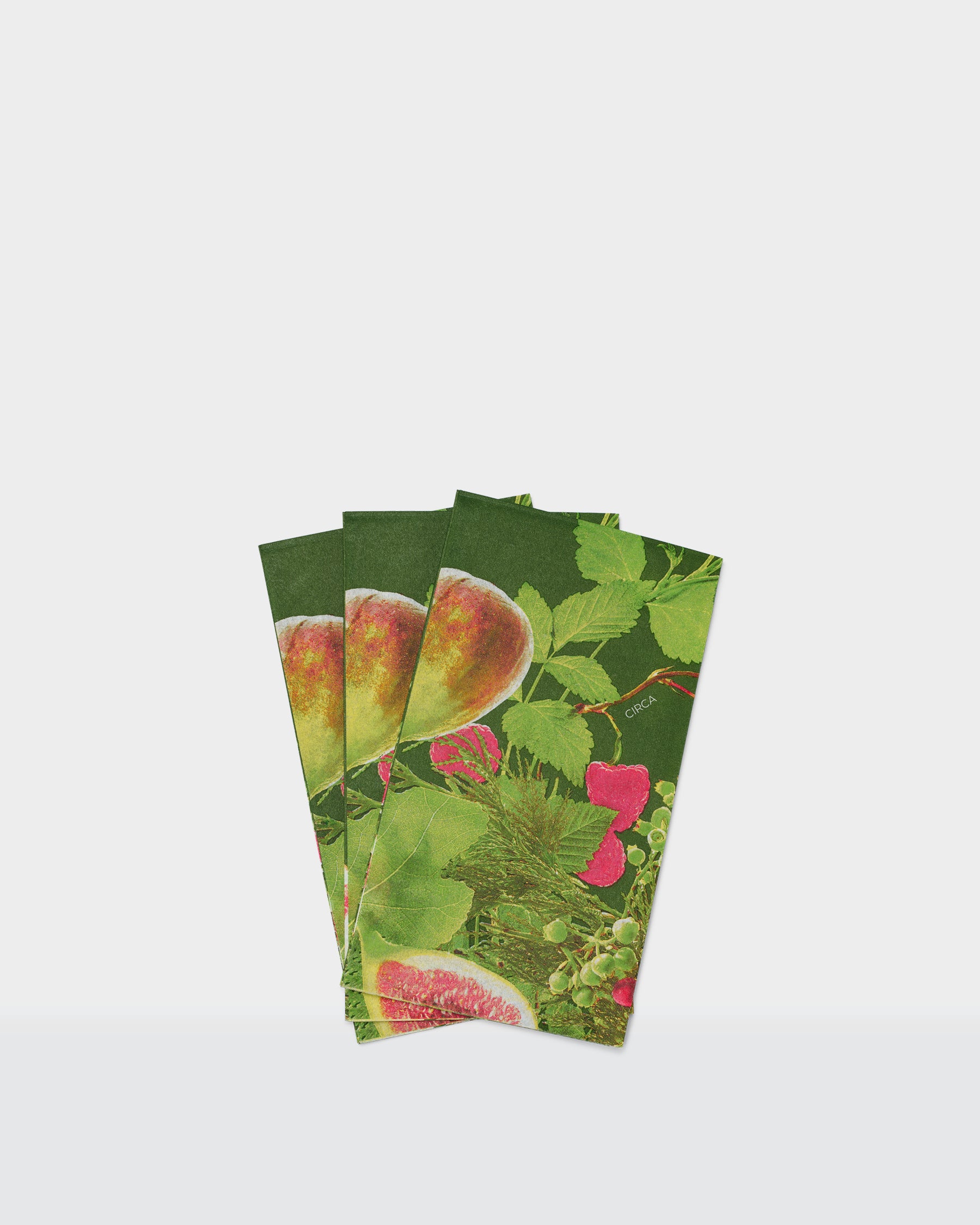 Festive paper dinner napkins with figs, green leaves and pink floral details.