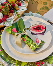 Festive paper dinner napkins with figs, green leaves and pink floral details.
