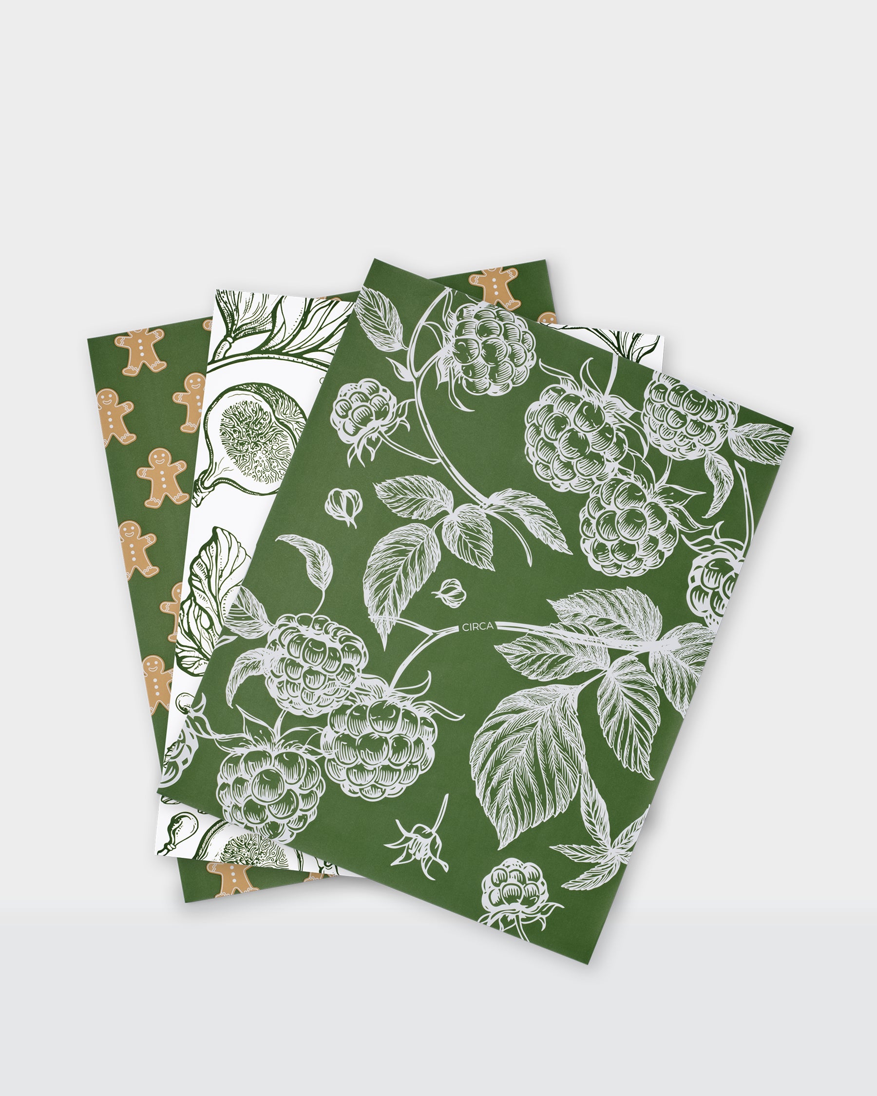 Festive greaseproof paper featuring green botanical prints and gingerbread designs.