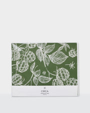 Festive greaseproof paper featuring green botanical prints and gingerbread designs.