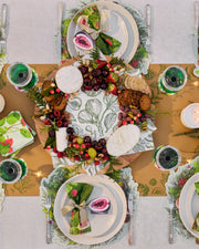 Festive Tableware Pack with green botanical paper tableware and cream bow napkin rings.