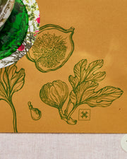 Festive paper table runner in warm brown with green botanical borders.