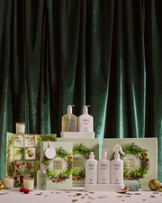 White Tea & Wild Mint Kitchen Trio with other Christmas gift sets in a festive display against green velvet.