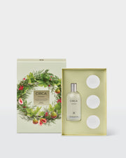 Oceanique gift set with 100ml Room & Linen Spray and three ceramic stones presented in an open botanical Christmas gift box.
